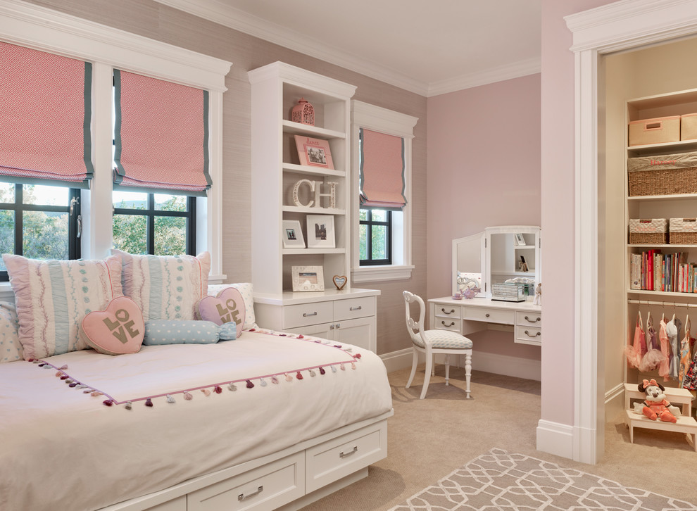 This is an example of a traditional children’s room for girls in San Francisco with pink walls, carpet and beige floors.