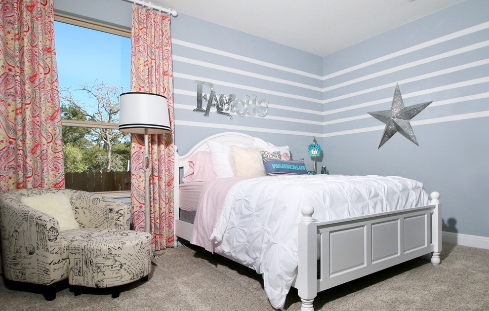 Photo of a medium sized classic children’s room for girls in Austin with blue walls and carpet.