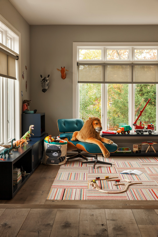 This is an example of a traditional gender neutral playroom in Philadelphia with grey walls and medium hardwood flooring.