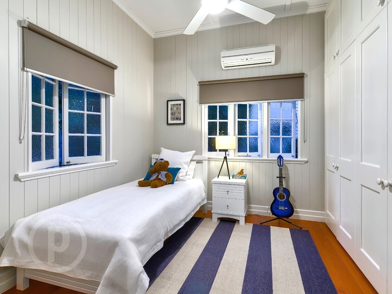 Inspiration for a small transitional boy medium tone wood floor kids' bedroom remodel in Brisbane with gray walls