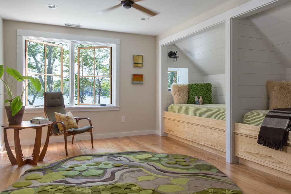 Design ideas for a medium sized traditional gender neutral children’s room in Portland Maine with beige walls, light hardwood flooring and brown floors.