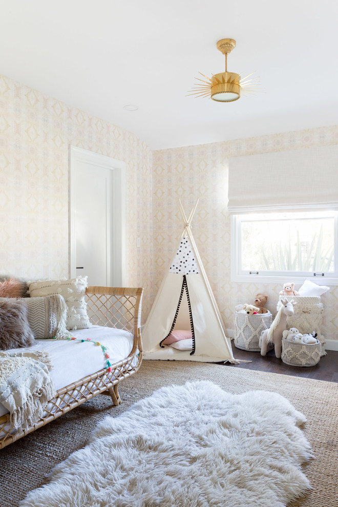 Design ideas for a beach style kids' bedroom for girls in Los Angeles with beige walls, dark hardwood flooring and feature lighting.