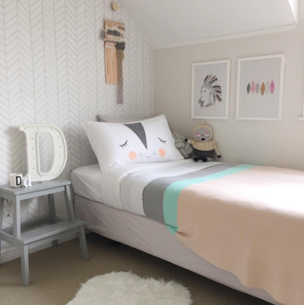 Medium sized contemporary toddler’s room for girls in Auckland with grey walls, carpet and beige floors.