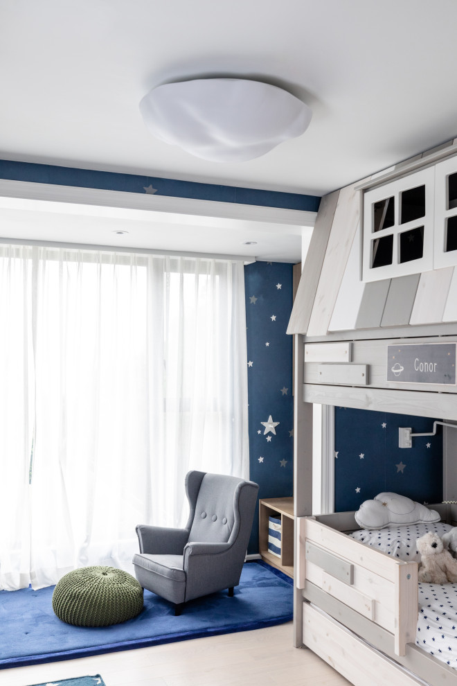 Inspiration for a medium sized contemporary toddler’s room for boys in Hong Kong with blue walls and beige floors.