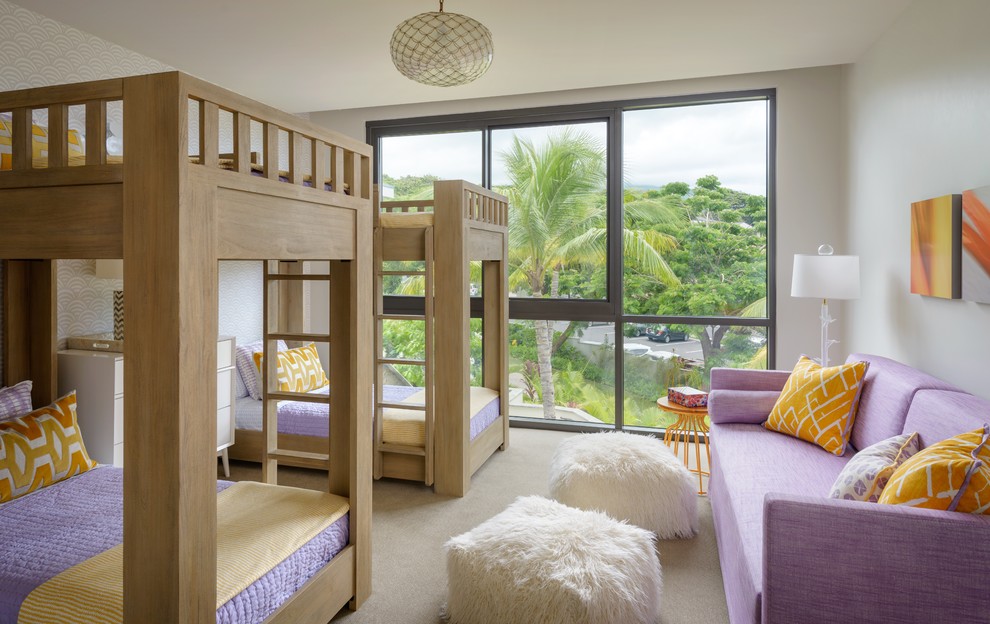 This is an example of a beach style kids' bedroom for girls in Hawaii with white walls, carpet and beige floors.