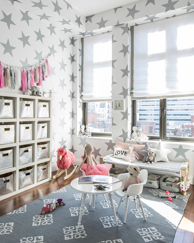 Example of a mid-sized trendy girl medium tone wood floor kids' room design in New York with multicolored walls