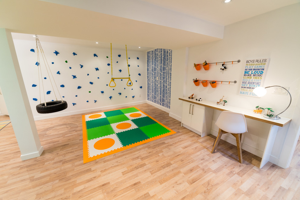 Inspiration for a modern gender neutral playroom in New York with blue walls and light hardwood flooring.