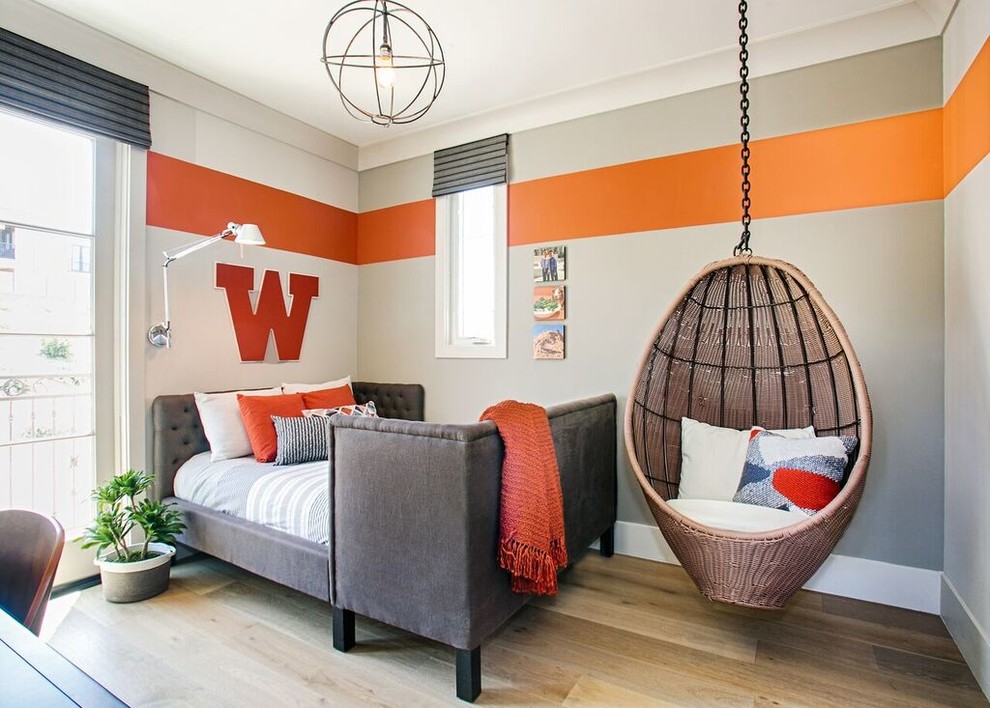 Inspiration for a mid-sized contemporary boy medium tone wood floor and brown floor kids' room remodel in Orange County with white walls