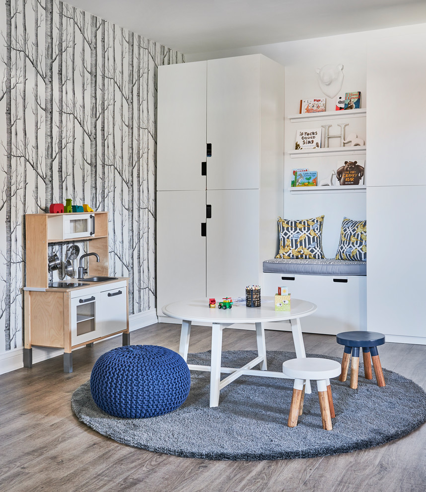 Design ideas for a traditional gender neutral playroom in Toronto with multi-coloured walls, medium hardwood flooring and grey floors.