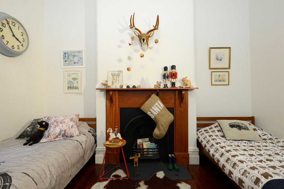 This is an example of an eclectic gender neutral children’s room in Adelaide with white walls, dark hardwood flooring and a chimney breast.