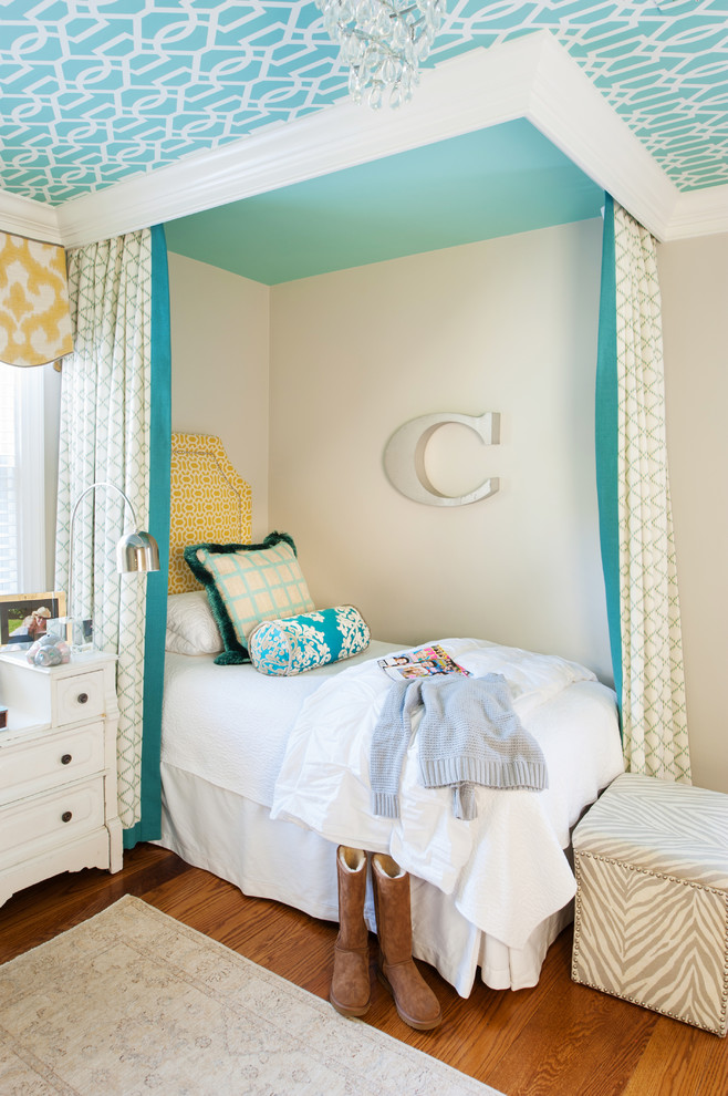 Cette photo montre une chambre d'enfant chic avec un mur beige et un sol en bois brun.