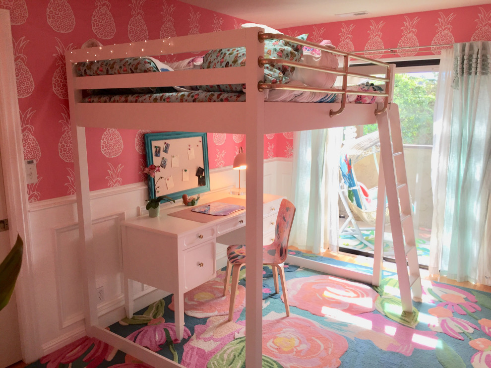 Kids' room - mid-sized tropical girl medium tone wood floor and wallpaper kids' room idea in San Francisco with pink walls