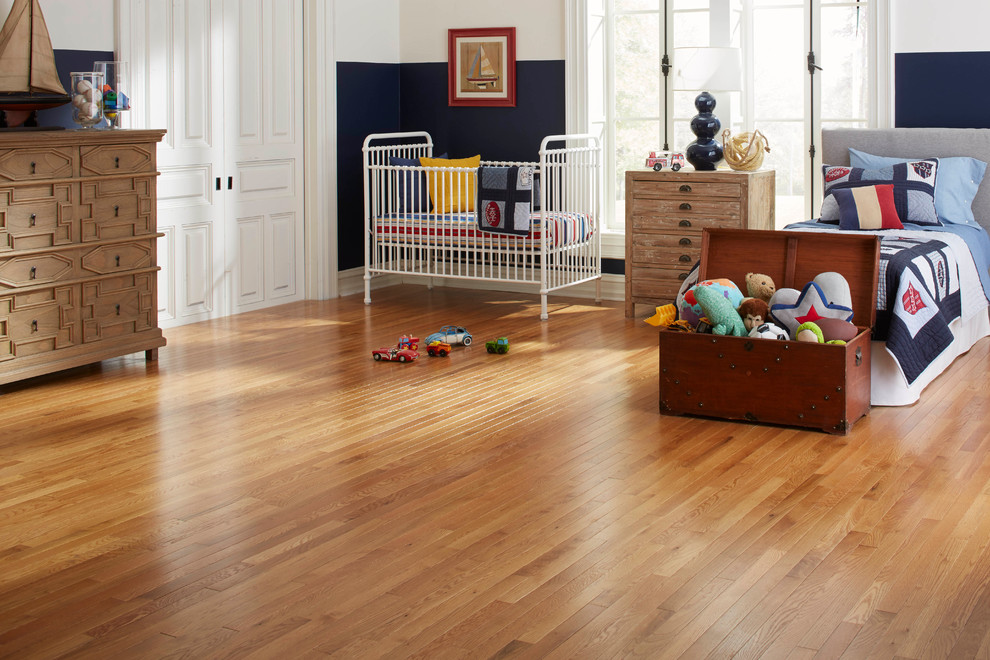 Example of a classic boy medium tone wood floor and brown floor kids' room design in Raleigh with blue walls