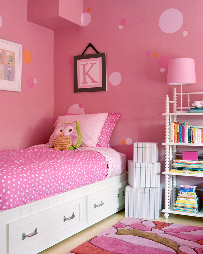 Inspiration for a traditional children’s room for girls in Los Angeles with pink walls and light hardwood flooring.