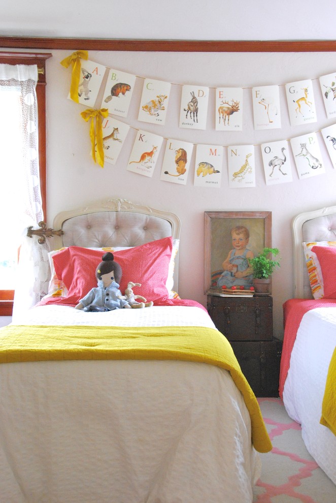 Inspiration for a medium sized bohemian children’s room for girls in San Francisco with pink walls.