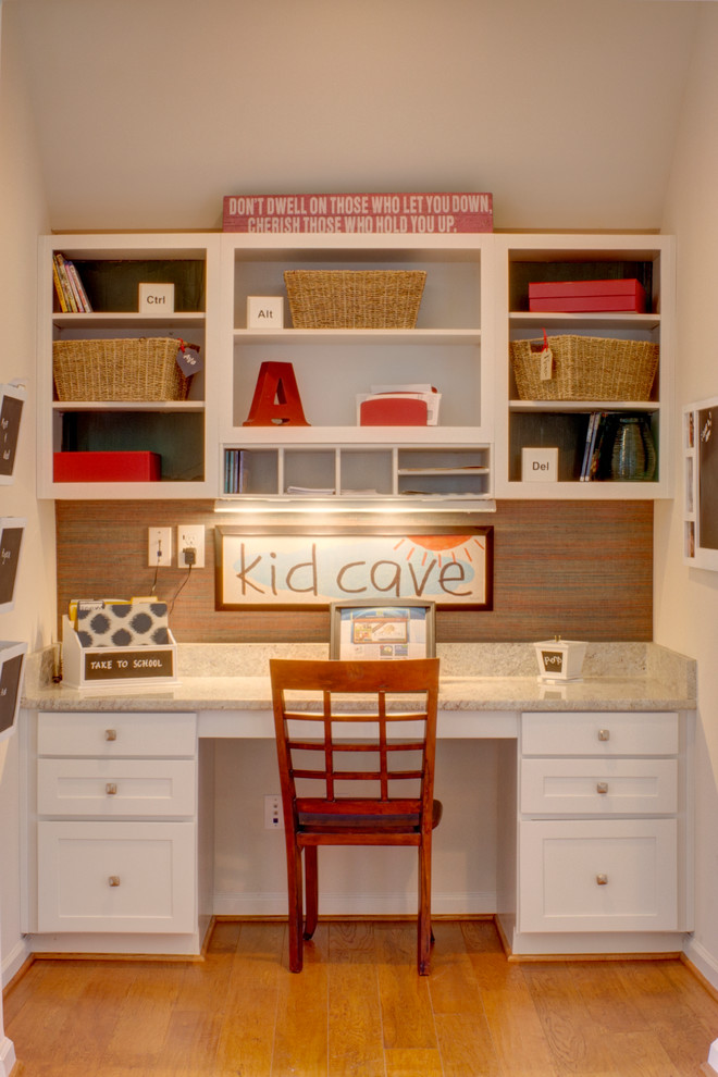 Inspiration for a timeless gender-neutral medium tone wood floor kids' study room remodel in Other with white walls