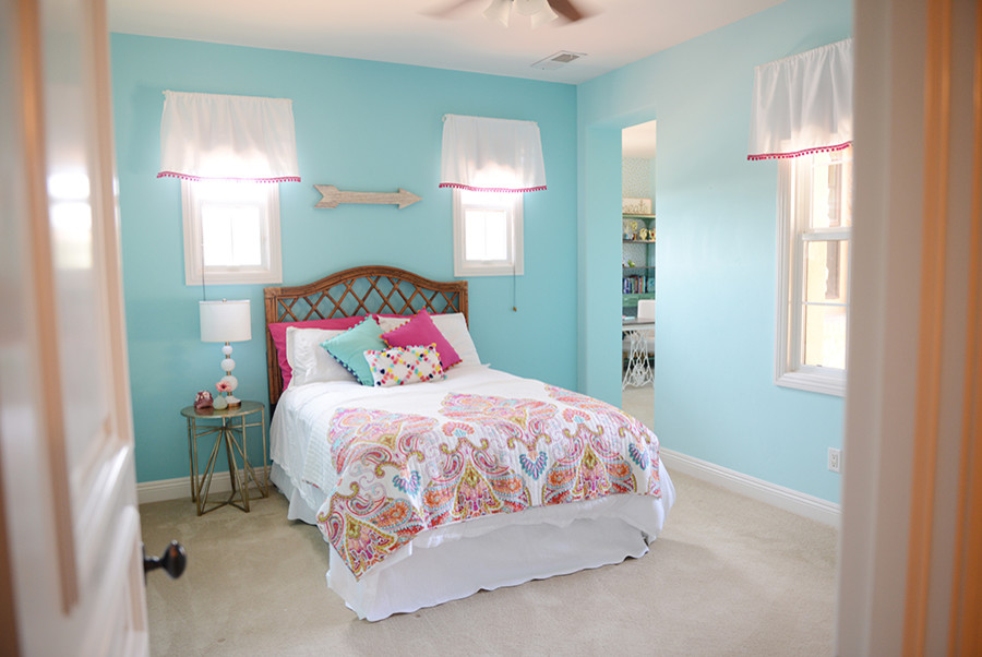 This is an example of a medium sized traditional teen’s room for girls in San Diego with blue walls, carpet and beige floors.