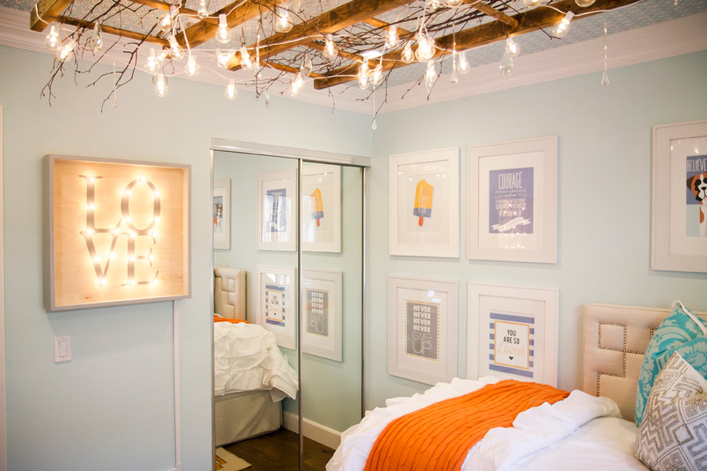 Inspiration for a mid-sized transitional girl dark wood floor kids' room remodel in San Diego with blue walls