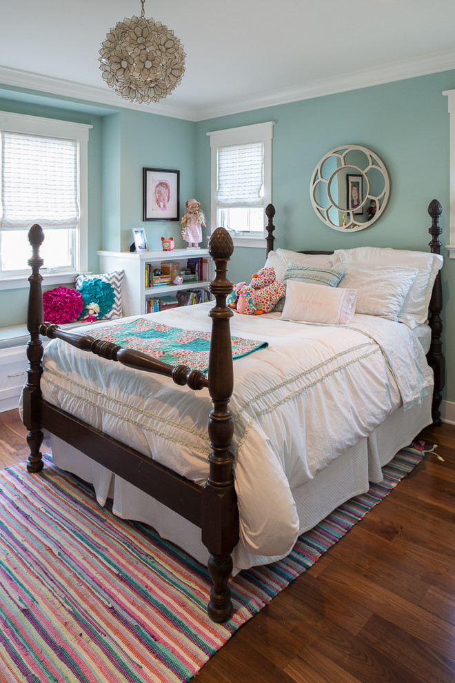 Photo of a traditional kids' bedroom for girls in San Francisco with blue walls and dark hardwood flooring.