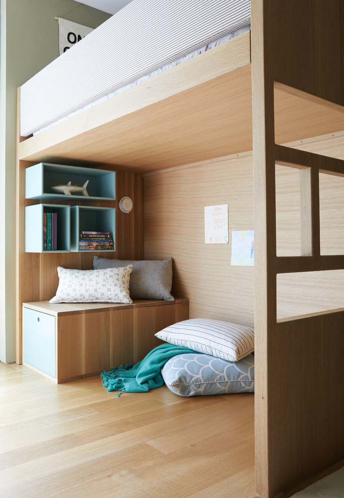 Example of a mid-sized minimalist gender-neutral light wood floor and brown floor kids' room design in San Francisco with beige walls