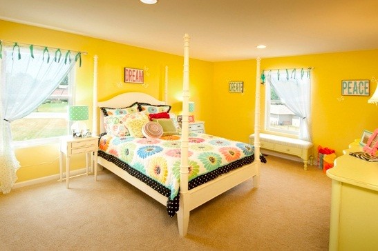 Mid-sized elegant girl kids' room photo in Other with yellow walls