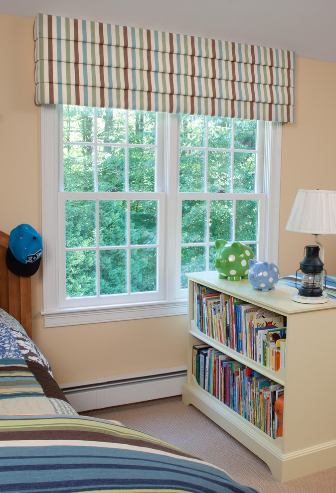 Photo of a medium sized traditional children’s room for boys in Boston with carpet, orange walls and beige floors.