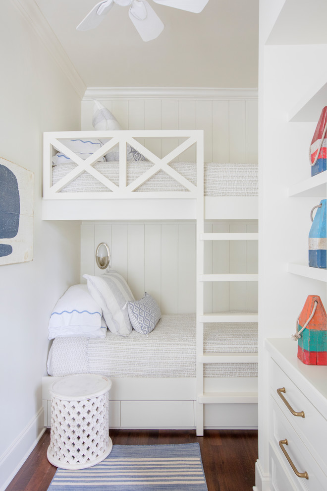 Beach style gender-neutral dark wood floor and brown floor kids' bedroom photo in Charleston with white walls