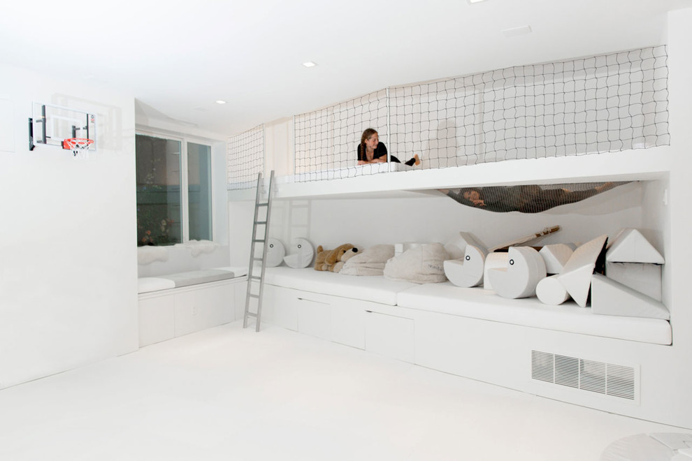 Design ideas for a medium sized modern gender neutral kids' bedroom in New York with white walls and white floors.