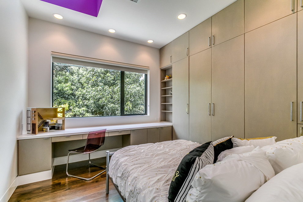Kids' bedroom - small modern medium tone wood floor kids' bedroom idea in Houston