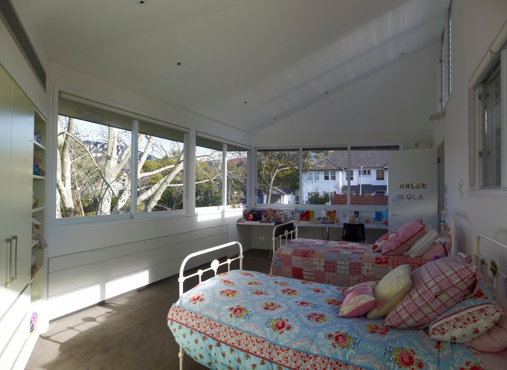 Immagine di una piccola cameretta per bambini da 4 a 10 anni contemporanea con pareti bianche, moquette e pavimento beige