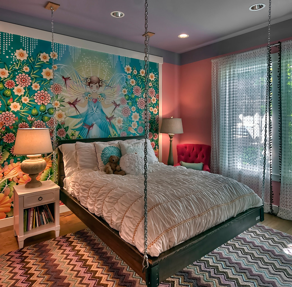 Example of a transitional girl medium tone wood floor kids' room design in Seattle with multicolored walls