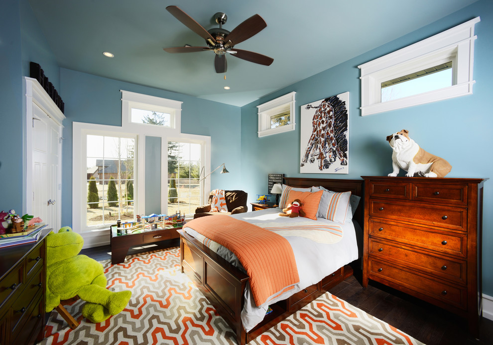 Exempel på ett mellanstort klassiskt pojkrum kombinerat med sovrum och för 4-10-åringar, med blå väggar och mellanmörkt trägolv