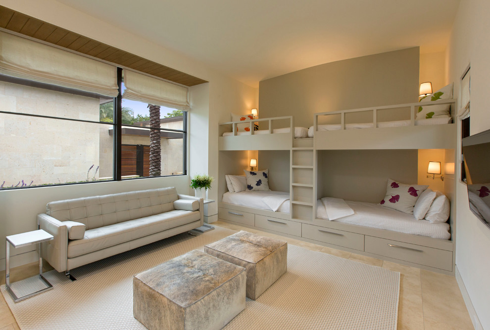 Imagen de dormitorio infantil actual grande con suelo de piedra caliza y paredes beige