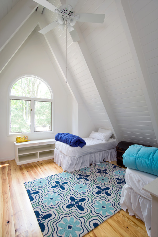 This is an example of a large coastal gender neutral children’s room in Atlanta with white walls.