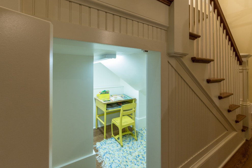 Example of a small classic gender-neutral medium tone wood floor kids' study room design in Other with white walls