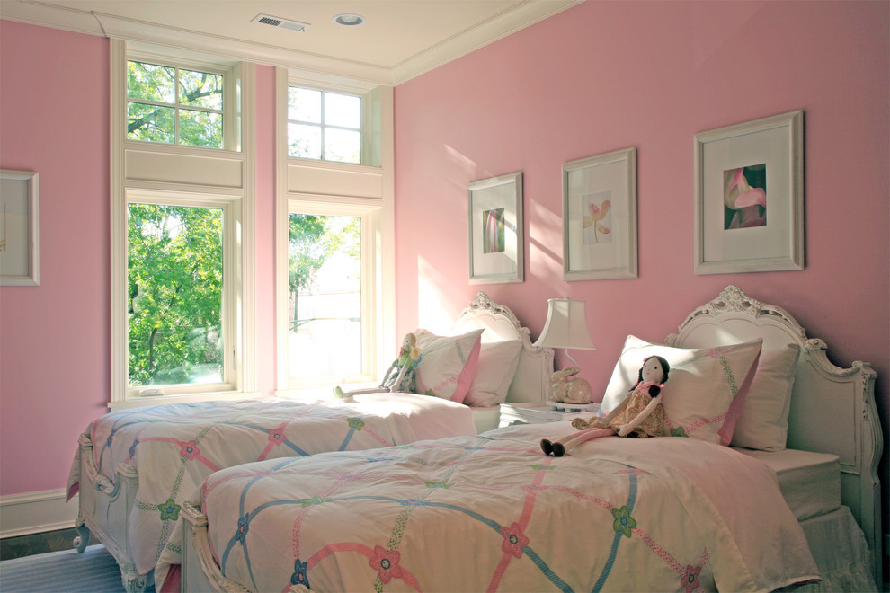 Photo of an expansive classic toddler’s room for girls in Chicago with pink walls and dark hardwood flooring.