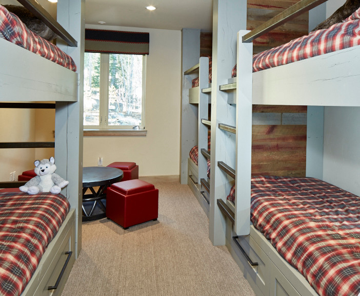 Medium sized classic gender neutral children’s room in Denver with carpet, beige walls and beige floors.
