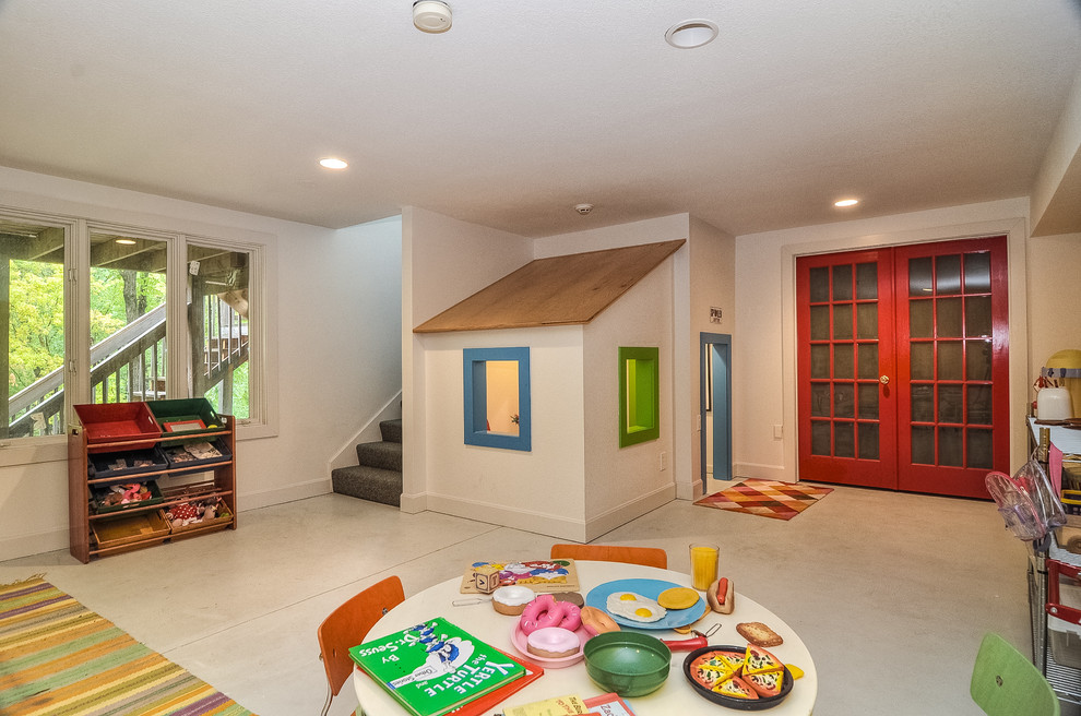 Contemporary gender neutral playroom in Kansas City with white walls.
