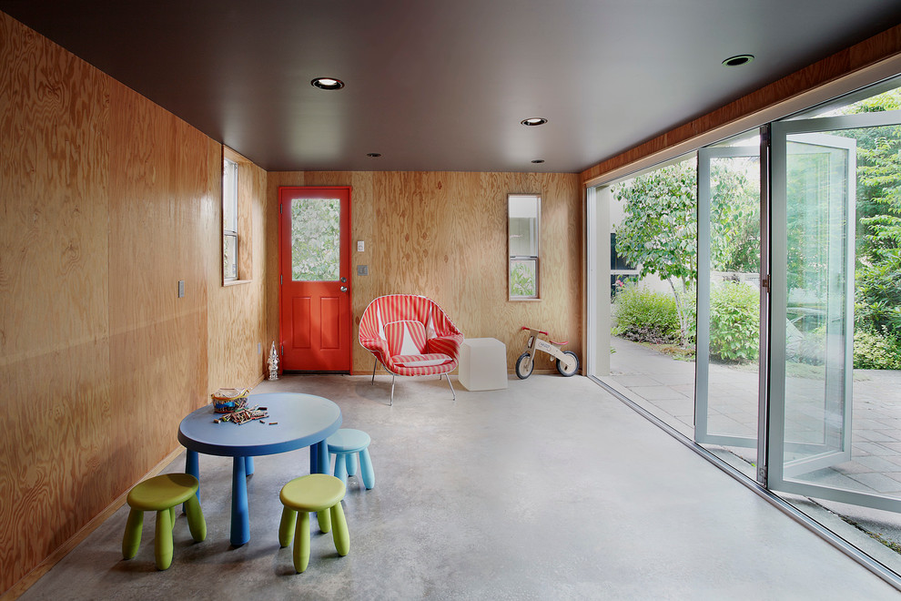 Exempel på ett modernt barnrum kombinerat med lekrum, med betonggolv och grått golv