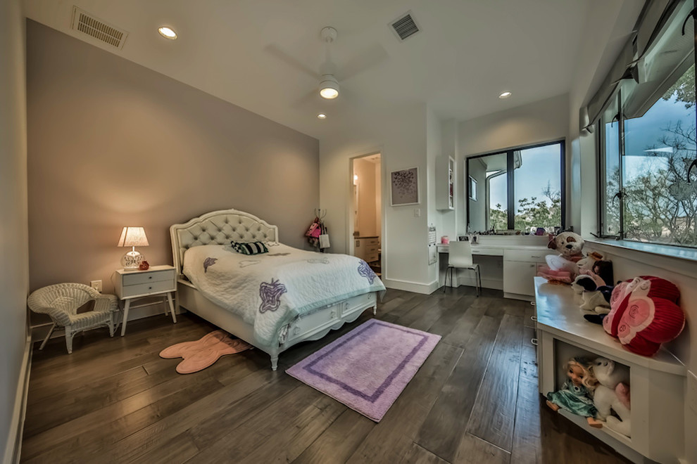 Expansive contemporary gender neutral children’s room in Houston with beige walls and medium hardwood flooring.