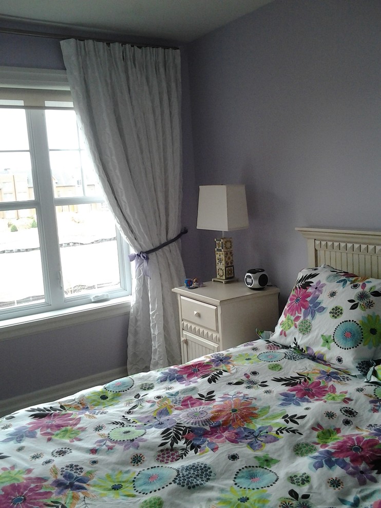 This is an example of a medium sized traditional teen’s room for girls in Montreal with purple walls.