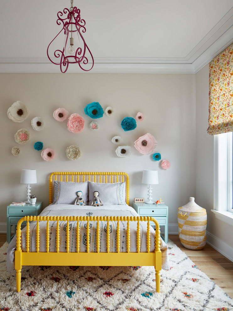 Design ideas for a traditional children’s room for girls in Chicago with beige walls, medium hardwood flooring and brown floors.