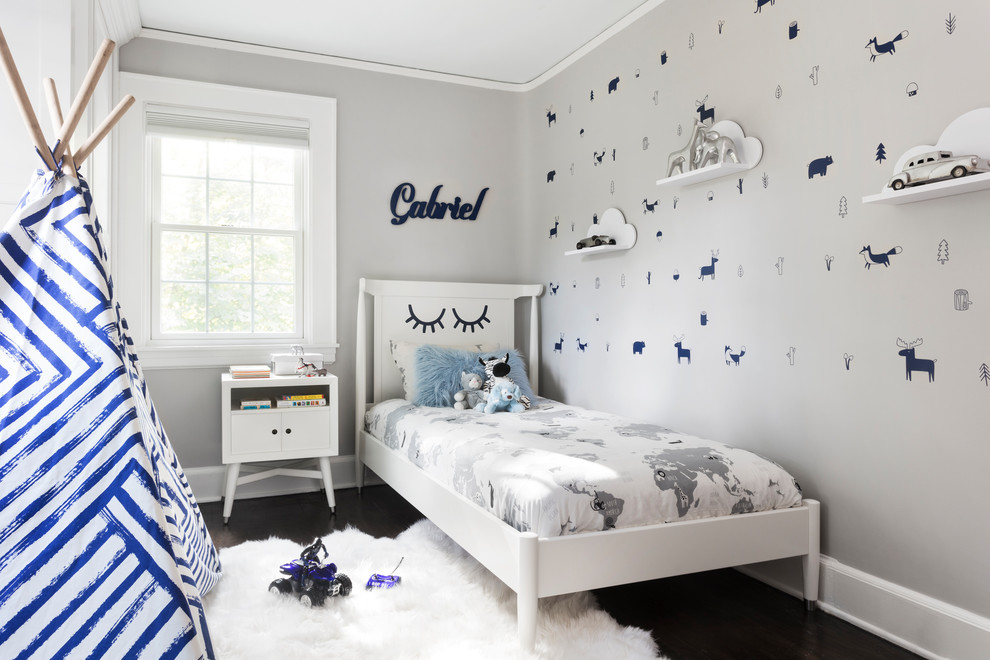 Kids' room - small transitional boy dark wood floor and brown floor kids' room idea in New York with gray walls