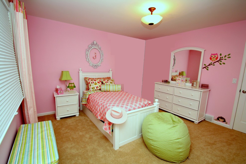 Example of a mid-sized classic girl carpeted kids' room design in Denver with pink walls
