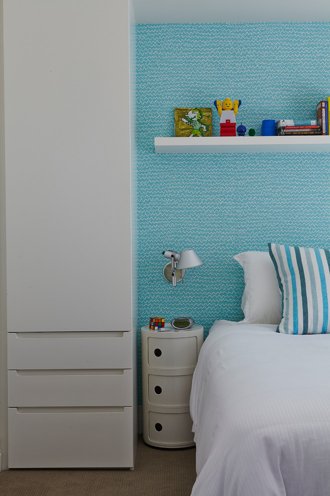 Idée de décoration pour une chambre d'enfant design avec un mur bleu.