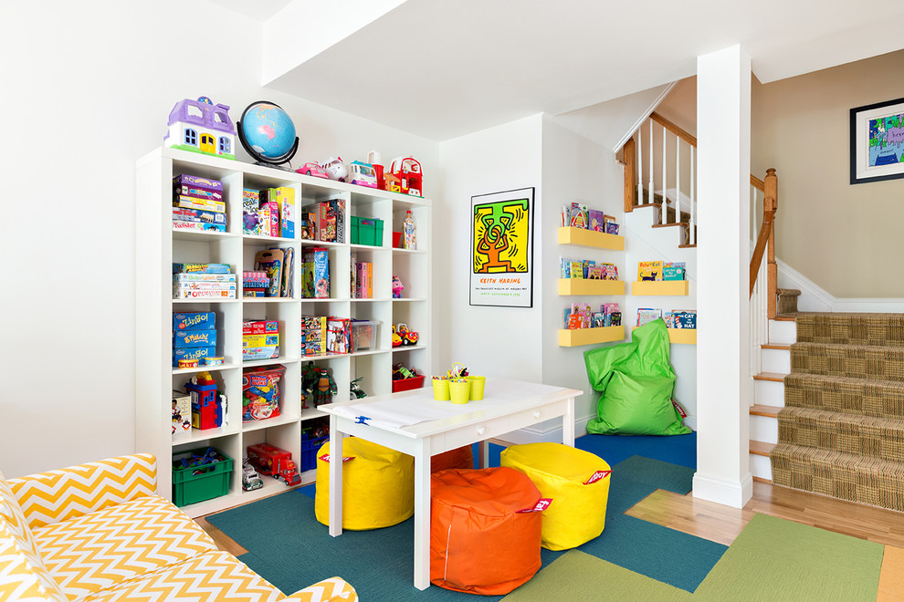 This is an example of a classic gender neutral kids' bedroom in New York with white walls and light hardwood flooring.