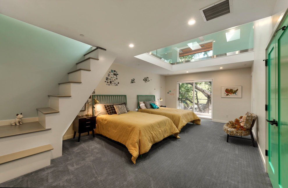 This is an example of a large contemporary gender neutral teen’s room in San Francisco with white walls, carpet and grey floors.