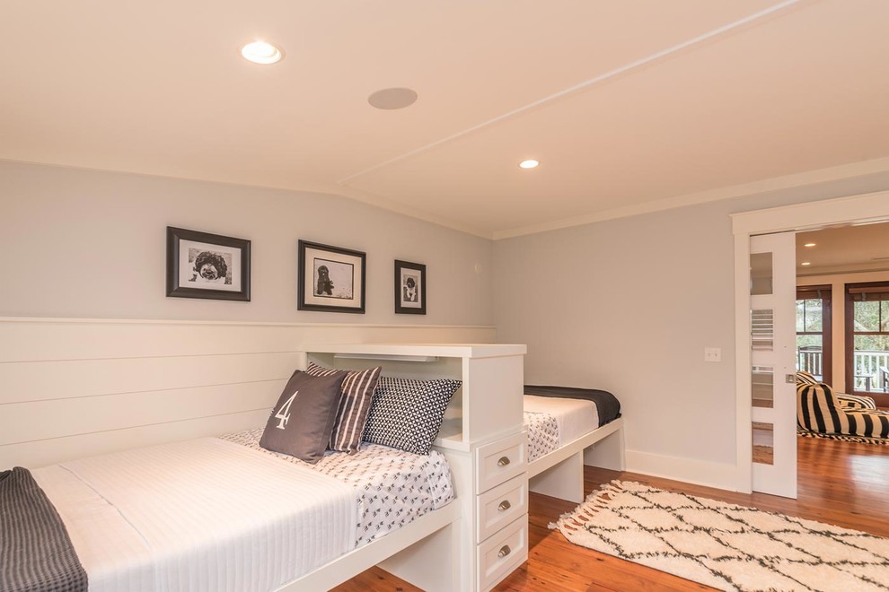 Large beach style gender-neutral medium tone wood floor and brown floor kids' bedroom photo in Atlanta with gray walls