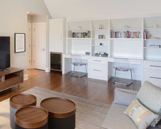 This is an example of an expansive contemporary gender neutral kids' bedroom in Calgary with white walls, light hardwood flooring and brown floors.