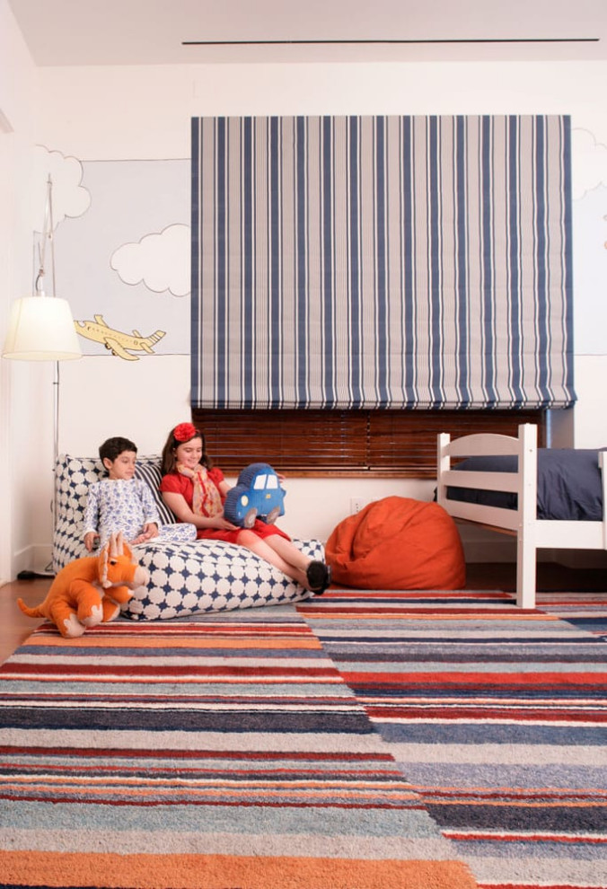 Inspiration for a medium sized modern gender neutral kids' bedroom in New York with medium hardwood flooring.